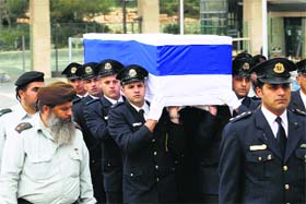 Members of the Knesset guard carry the coffin of former Israeli Prime Minister Ariel Sharon in Jerusalem on Sunday