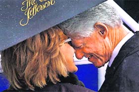 Former President Bill Clinton and his wife Hillary Rodham Clinton share a moment under an umbrella before the rainy inauguration of democratic Virginia Gov. Terry McAuliffe in Richmond on Saturday
