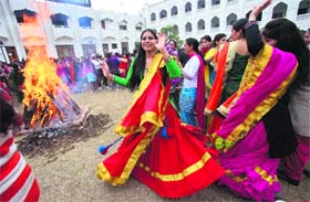 Khalsa College for Women staff and girls celebrate the Lohri festival in Amritsar on Monday