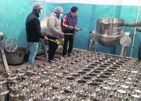 Cooked food being packed for mid-day meal at a new kitchen established in Amritsar