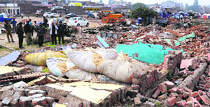 Debris lies scattered after illegal commercial establishments were demolished by GMADA on the Sohana-Lakhnur road on Monday. 
