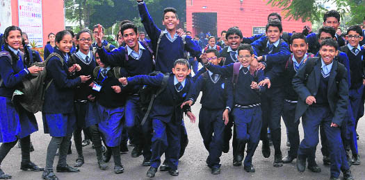 Students of a government school in a cheerful mood after the winter break in Chandigarh on Monday.