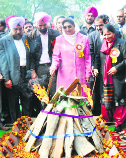 Rajinder Kaur Bhattal and Geeta Bhukkal attend a Lohri function in Karnal on Monday.