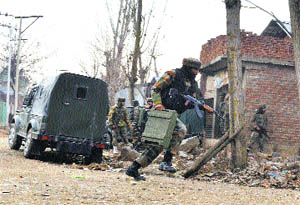 Army soldiers rush to seal the Dooru area in Sopore where a gun battle erupted with militants on Monday.