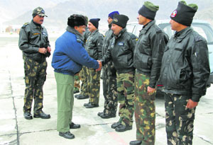 Indian Air Force Chief Arup Raha shakes hands with Army personnel in Leh on Monday.