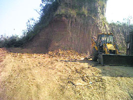 A JCB machine digging up a hillock at Bhatoli village in Ropar district on Sunday. 