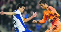 Real Madrid's Cristiano Ronaldo duels for the ball against Espanyol's Sidnei Rechel during their La Liga match on Sunday. AP/PTI