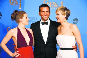 American Hustle stars Amy Adams (left), Bradley Cooper (centre) and Jennifer Lawrence at the 71st annual Golden Globe Awards at Beverly Hills in California on Monday