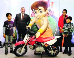 Honda Motorcycle president & CEO Keita Muramatsu with Chhota Bheem launch kids motorcycle in New Delhi on Tuesday.  PTI 
