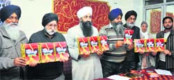 Members of the Jammu and Kashmir Sikh Council release Punjabi book Des Hoia Pardes during a function in Jammu on Tuesday. Tribune photo: Inderjeet Singh