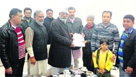 A social worker presents a memorandum to Health Minister Surjit Jyani, seeking help for thalassaemia patients, in Fazilka.