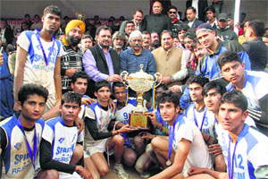 Tamil Nadu spikers strike a pose with the trophy.