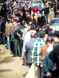 People queue up to cast their vote in Cairo Giza district on Tuesday