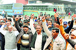 Roadways employees protest against state government at a bus stand in Karnal on Wednesday