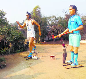 The statues of athlete Milkha Singh and hockey legend Dhyan Chand being given final touches in Ludhianas Jarkhar village district on Wednesday.