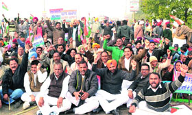 Congress workers hold a protest by blocking traffic on the Bathinda-Mansa flyover on Thursday.