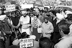 Protesting Congress leaders and workers block the Chandigarh-Ambala highway at Dera Bassi on Thursday