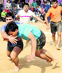 Police personnel take part in the kabaddi