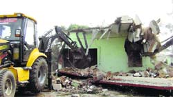 An unauthorised construction being demolished on the Sonepat-Rathdhana road in Sonepat on Thursday. Photo: BS Malik