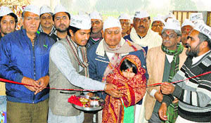 A child inaugurates the district office of AAP in Una on Thursday. 