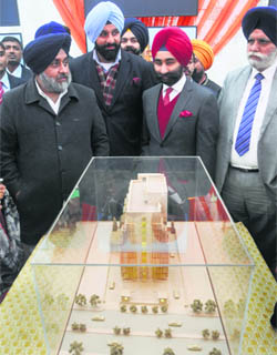 Deputy Chief Minister Sukhbir Singh Badal along with Revenue Minister Bikram Singh Majithia and Shivinder Mohan Singh (in red turban), MD, Fortis Healthcare, looks at the model  of the Fortis La Femme in Ludhiana on Thursday. 