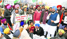 PPCC chief Partap Bajwa addresses protesters in Landran village in Mohali on Thursday.