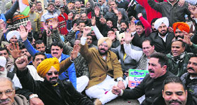 PPCC general secretary Fateh Jung Bajwa leads a protest on Bhandari Bridge in Amritsar.