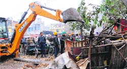 GMADA officials remove encroachments at Phase I in Mohali on Friday. Tribune photo: Vicky Gharu