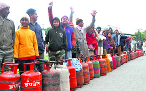 Customers of Shiva Gas Agency raise slogans against the firm in Dehradun on Friday
