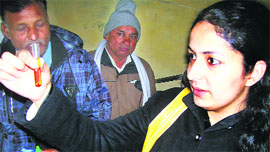 Chief Judicial Magistrate Harleen A Sharma tests a water sample for pollution at Jind on Thursday.
