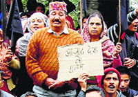 Villagers stage a dharna near the Chandmari Terra Line against the Army near Dharamsala on Friday.