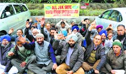 Members of the J&K SRTC Volunteer Retirement Employees Association protest outside Exhibition Ground in Jammu on Friday. Tribune photo: Inderjeet Singh
