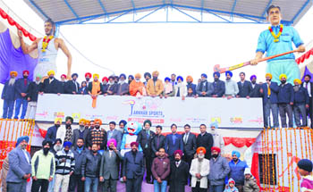 Organisers of the 28th Coca Cola Jarkhar Sports Festival and guests after unveiling the statues of the Flying Sikh, Milkha Singh, and hockey legend Dhyan Chand at Jarkhar village in Ludhiana district on Friday. 