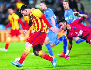 Barcelonas Lionel Messi scores his second goal against Getafe during their Spanish King's Cup match on Thursday. 