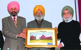 Honorary secretary, Khalsa College governing council, Rajinder Mohan Singh Chhina (centre) and college principal Daljit  Singh (left) honour Canadian art historian Bhupinder Singh Marwah at Khalsa College in Amritsar on Saturday