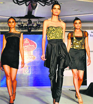 Models sashay down the ramp during a fashion show at the JW Marriott hotel in Chandigarh on Saturday.