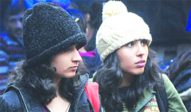 Girls cover themselves with woollens on chilly Saturday in New Dlehi.