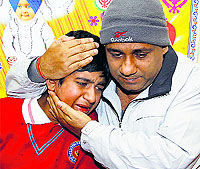 The woman's husband consoles their son
