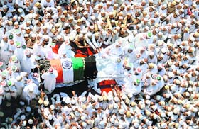 18 killed in stampede: Bohra Muslims gather around the coffin of their spiritual leader Syedna Mohammed Burhanuddin during his funeral procession in Mumbai