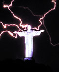 The statue of Christ the Redeemer hit by lightning at the Corcovado hill at Rio de Janeiro