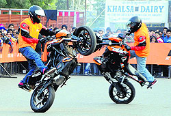 Bikers perform stunts at a promotional event in Amritsar on Sunday