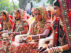 Girls take part in a mass marriage ceremony organised by the Rotary Club in Amritsar on Sunday
