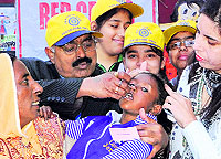 Health department officials administer polio drops to a child in Amritsar on Sunday