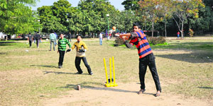 Children play cricket in a green belt at Sector 20 in Chandigarh. 