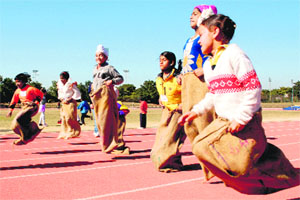 Game for sports: Students from orphanages participate in a sack race during the KidOlympics conducted at Tau Devi Lal Stadium in Sector 3, Panchkula, on Sunday