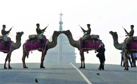 BSF jawans mounting camels during a rehearsal for the Beating Retreat ceremony at Vijay Chowk in New Delhi on Sunday