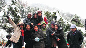 A group of girls enjoying snow in Mussoorie on Sunday.