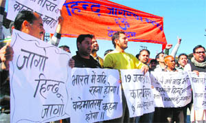 Members of the Hindu Jagran Manch hold a protest at Clock Tower in Dehradun on Sunday. 