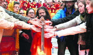 Eight-time national table tennis champion Indu Puri performs aarti with Swami Chidanand at Parmarth Niketan at a Ganga ghat in Haridwar on Saturday. 