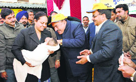 Health Minister Kaul Singh Thakur administers a polio drop to a child at Badsar in Hamirpur on Sunday.